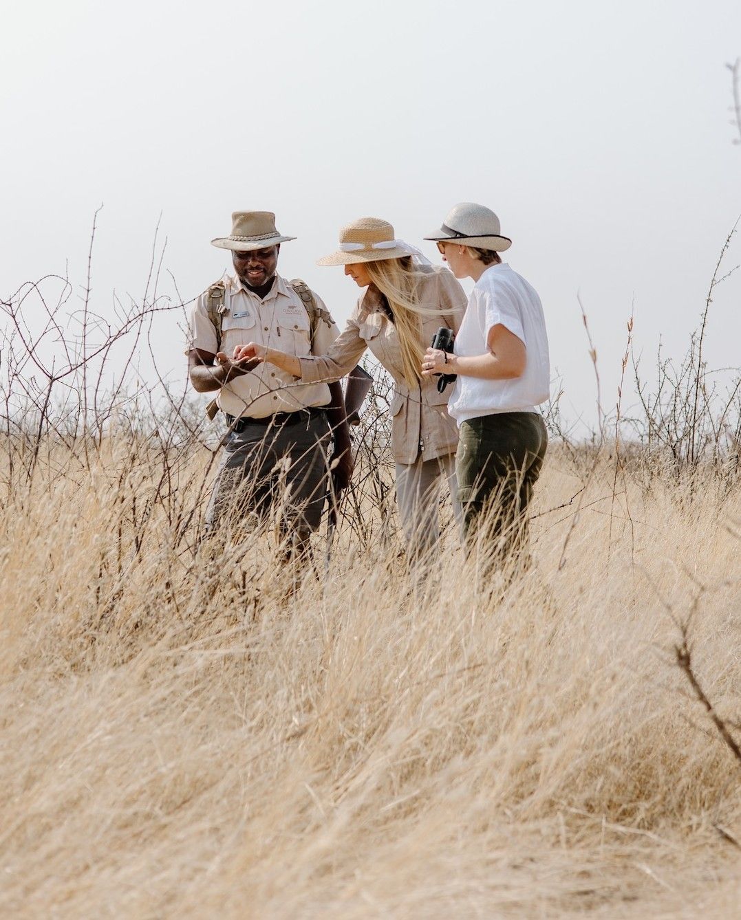 A guide with guests on a private walking safari